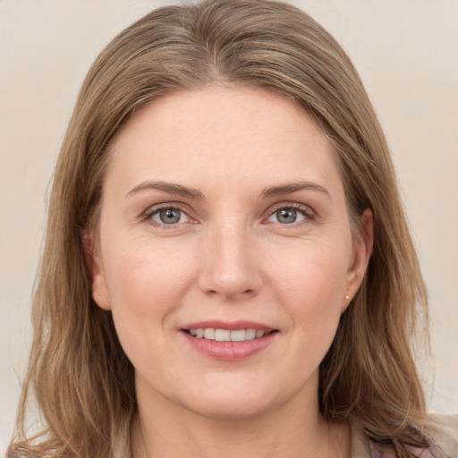 Joyful white young-adult female with long  brown hair and grey eyes