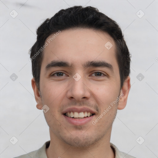 Joyful white young-adult male with short  black hair and brown eyes