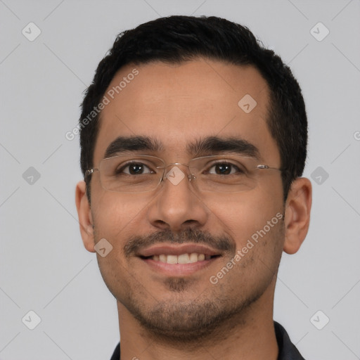 Joyful latino young-adult male with short  black hair and brown eyes