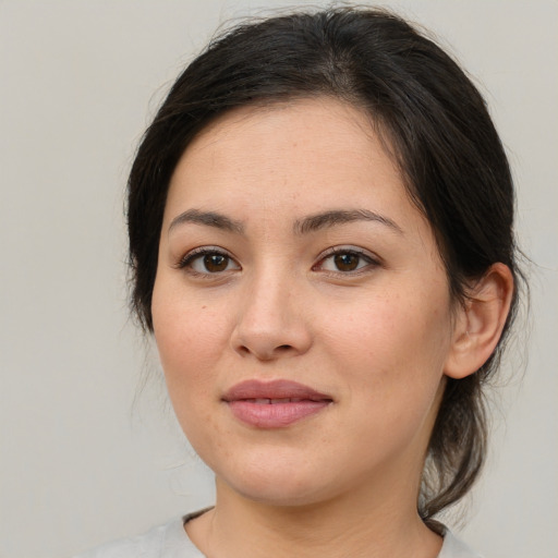 Joyful asian young-adult female with medium  brown hair and brown eyes