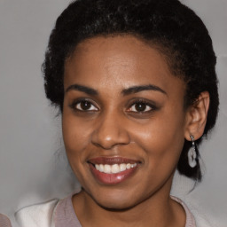 Joyful black young-adult female with medium  brown hair and brown eyes