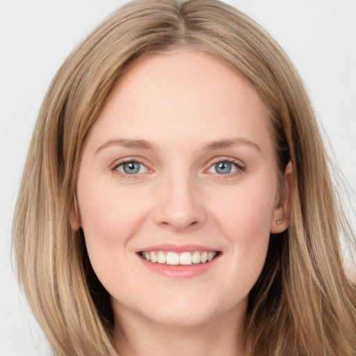 Joyful white young-adult female with long  brown hair and grey eyes