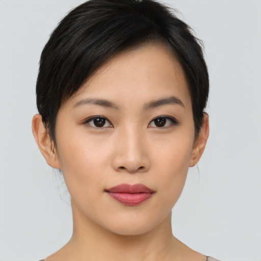 Joyful asian young-adult female with short  black hair and brown eyes