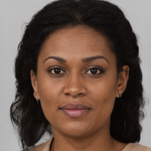 Joyful black adult female with medium  brown hair and brown eyes