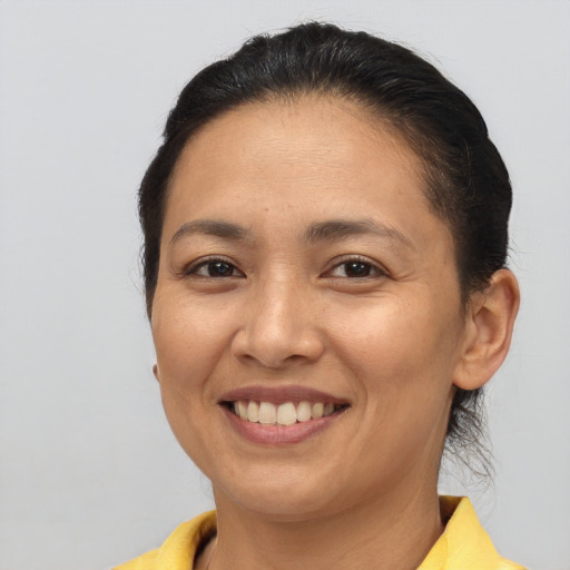 Joyful asian young-adult female with short  brown hair and brown eyes