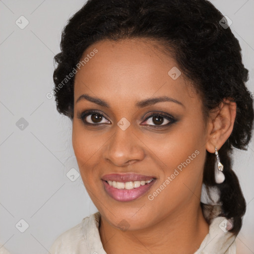 Joyful black young-adult female with long  brown hair and brown eyes