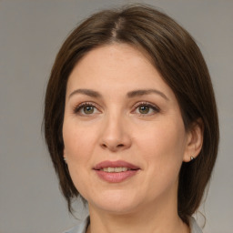 Joyful white adult female with medium  brown hair and brown eyes