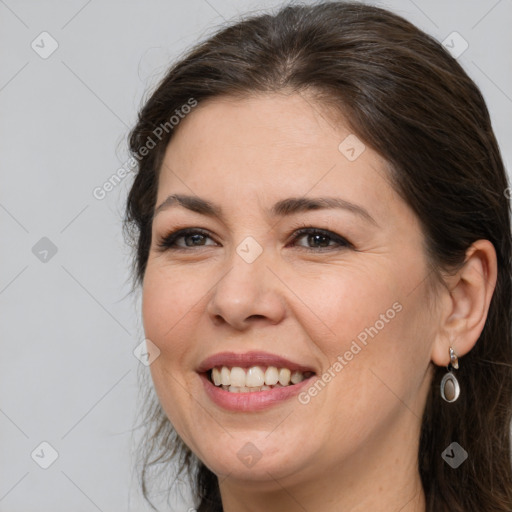 Joyful white adult female with medium  brown hair and brown eyes