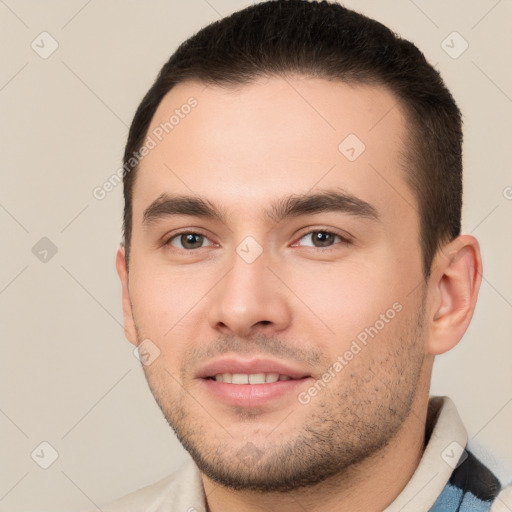 Joyful white young-adult male with short  brown hair and brown eyes