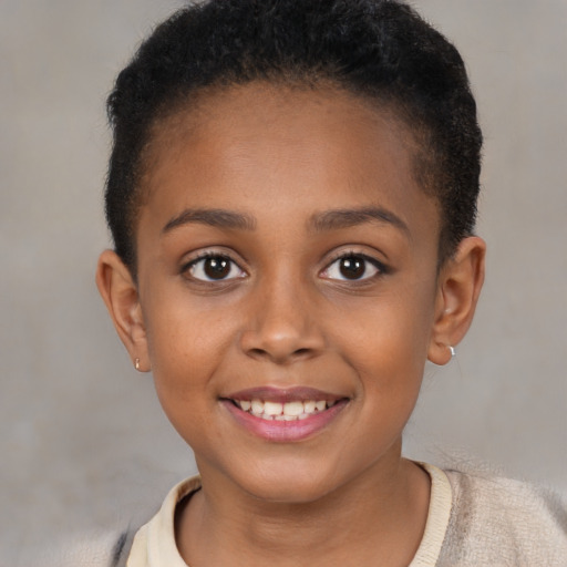 Joyful black child female with short  brown hair and brown eyes