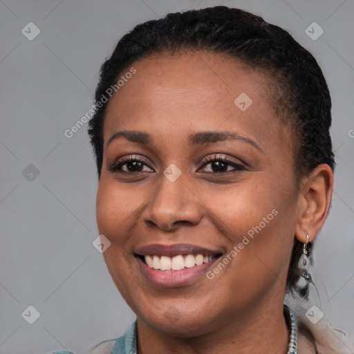 Joyful black young-adult female with short  brown hair and brown eyes