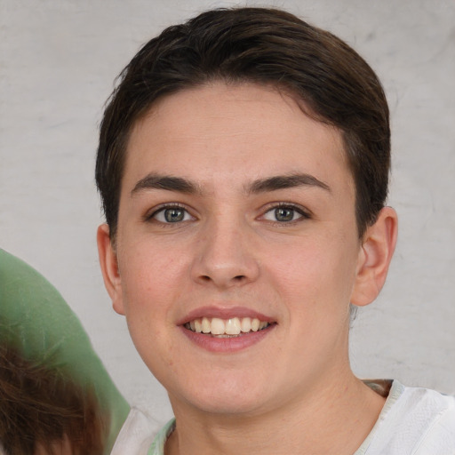 Joyful white young-adult female with short  brown hair and brown eyes