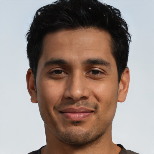 Joyful latino young-adult male with short  black hair and brown eyes