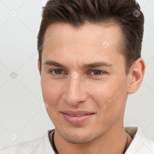 Joyful white young-adult male with short  brown hair and brown eyes