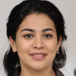 Joyful latino young-adult female with medium  brown hair and brown eyes