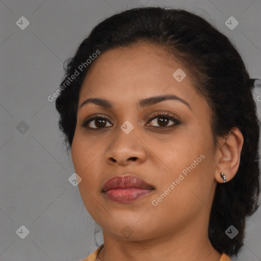 Joyful black young-adult female with long  brown hair and brown eyes