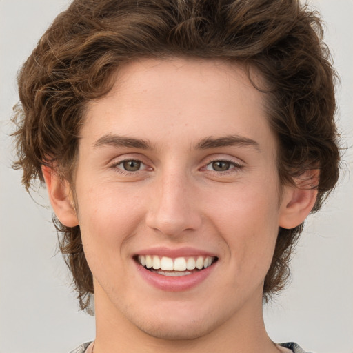 Joyful white young-adult female with medium  brown hair and green eyes