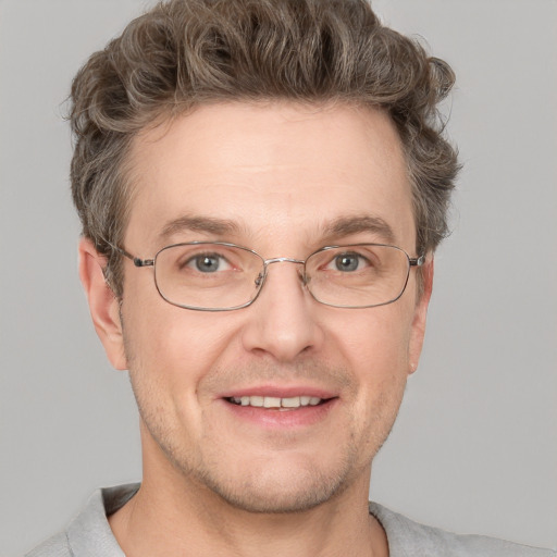 Joyful white adult male with short  brown hair and grey eyes