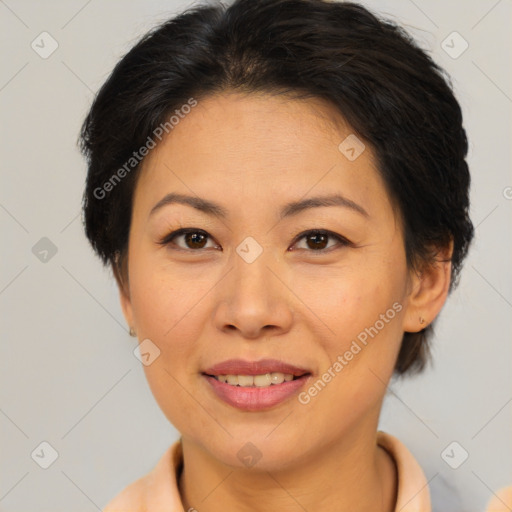 Joyful asian adult female with medium  brown hair and brown eyes