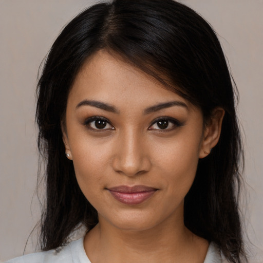 Joyful latino young-adult female with medium  brown hair and brown eyes