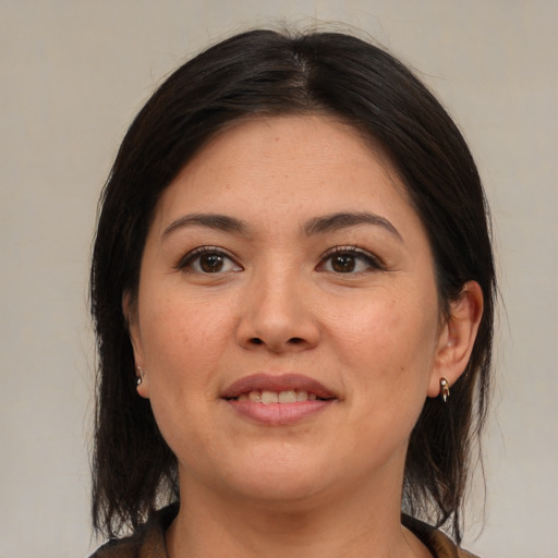 Joyful latino young-adult female with medium  brown hair and brown eyes