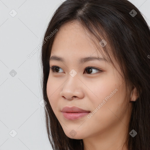 Joyful asian young-adult female with long  brown hair and brown eyes