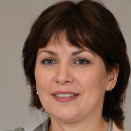 Joyful white adult female with medium  brown hair and brown eyes