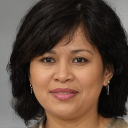 Joyful white adult female with medium  brown hair and brown eyes
