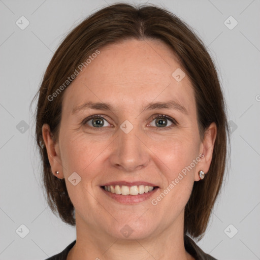 Joyful white adult female with medium  brown hair and grey eyes