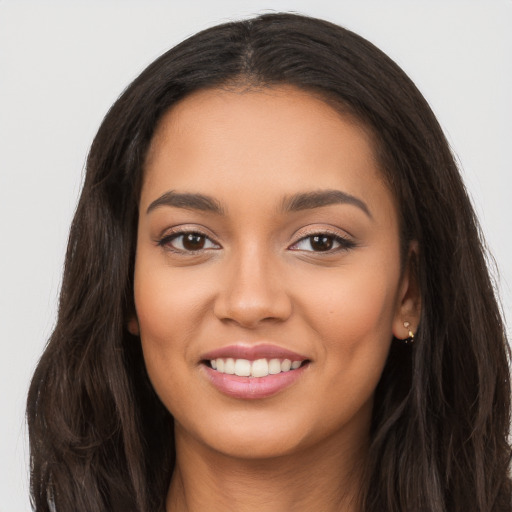 Joyful latino young-adult female with long  black hair and brown eyes