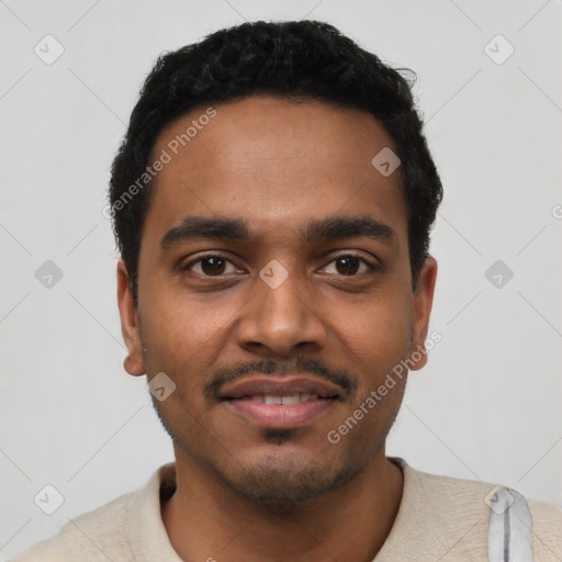 Joyful black young-adult male with short  black hair and brown eyes