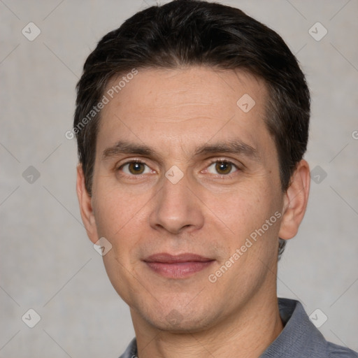 Joyful white adult male with short  black hair and brown eyes