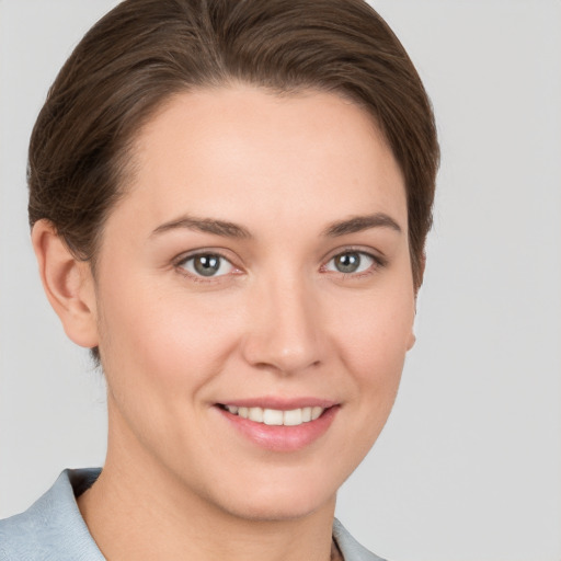 Joyful white young-adult female with short  brown hair and grey eyes