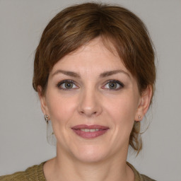 Joyful white young-adult female with medium  brown hair and grey eyes