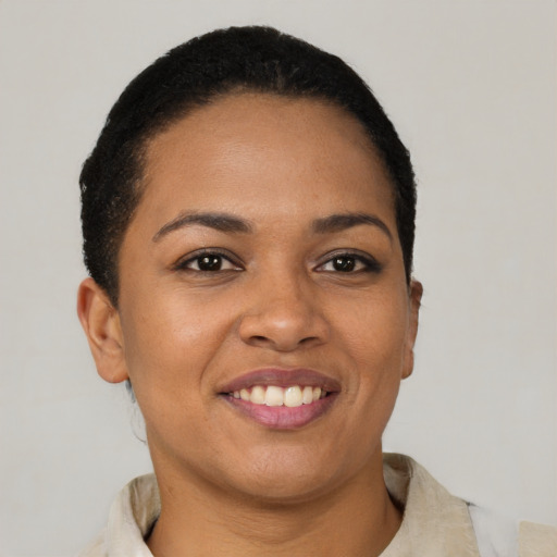 Joyful latino young-adult female with short  brown hair and brown eyes