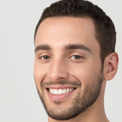 Joyful white young-adult male with short  black hair and brown eyes