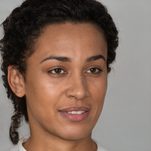 Joyful latino young-adult female with short  brown hair and brown eyes