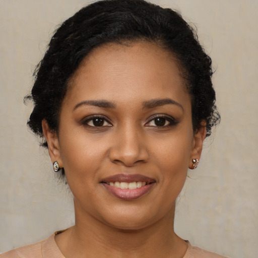 Joyful black young-adult female with short  brown hair and brown eyes