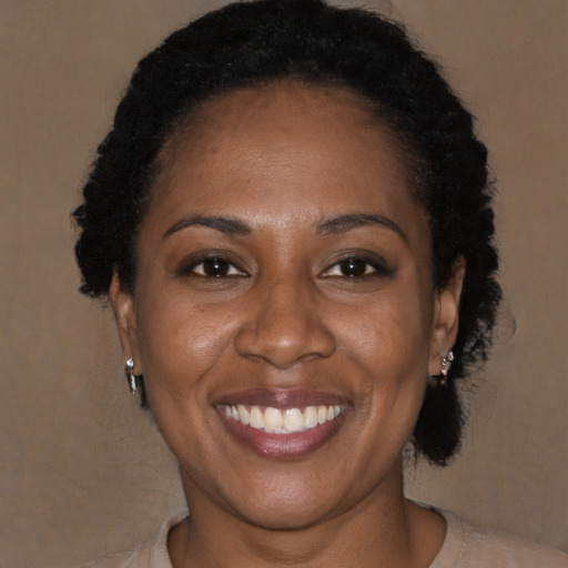 Joyful black adult female with short  brown hair and brown eyes