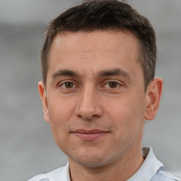 Joyful white adult male with short  brown hair and brown eyes