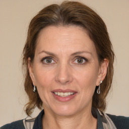 Joyful white adult female with medium  brown hair and blue eyes