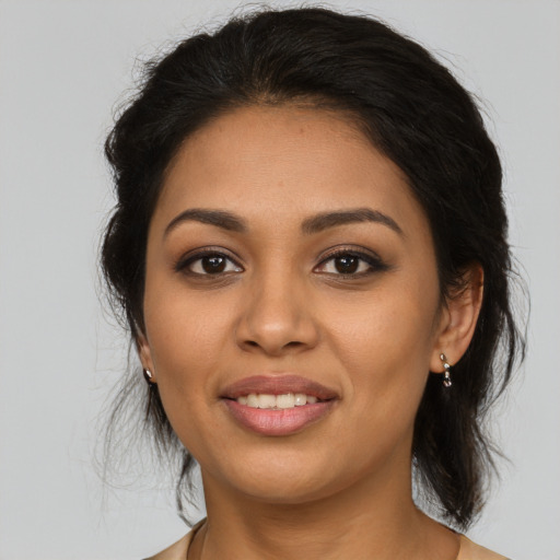 Joyful latino young-adult female with medium  brown hair and brown eyes