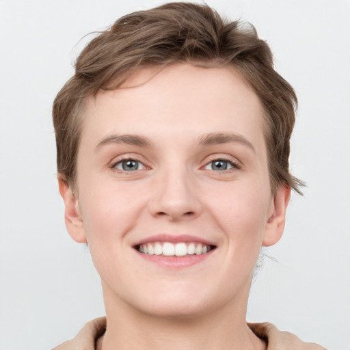 Joyful white young-adult female with short  brown hair and grey eyes