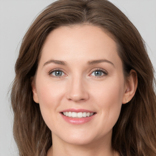 Joyful white young-adult female with long  brown hair and grey eyes