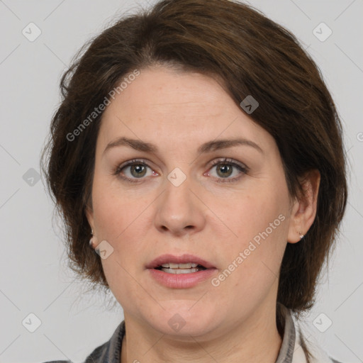 Joyful white adult female with medium  brown hair and grey eyes