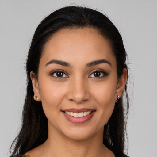 Joyful latino young-adult female with long  brown hair and brown eyes