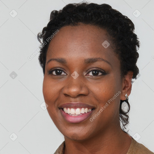 Joyful black young-adult female with short  brown hair and brown eyes