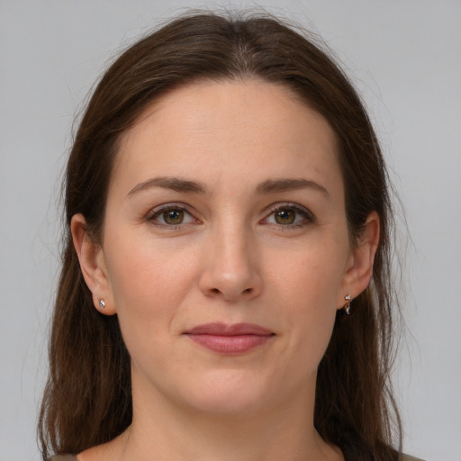 Joyful white young-adult female with long  brown hair and grey eyes