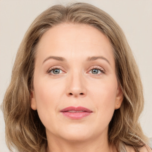 Joyful white adult female with long  brown hair and grey eyes