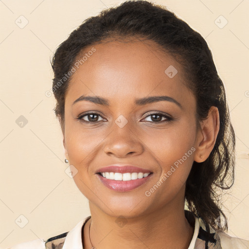 Joyful black young-adult female with long  brown hair and brown eyes